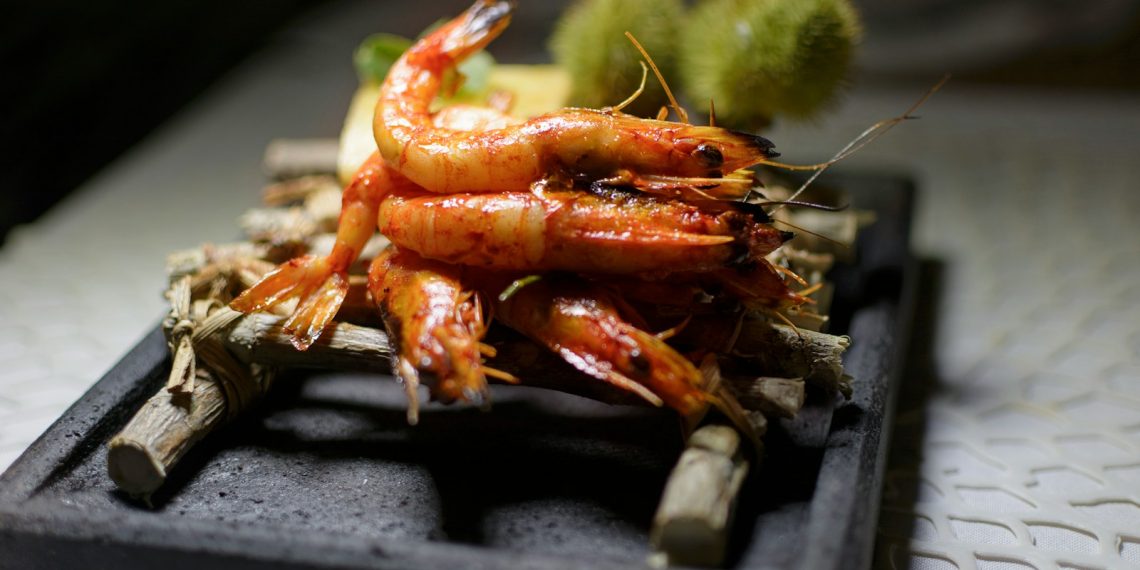 cooked prawns on bamboo stick