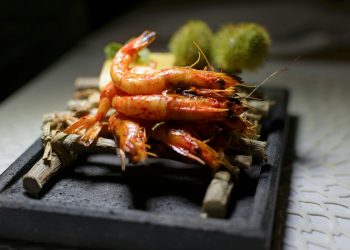 cooked prawns on bamboo stick